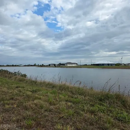 a view of a lake with houses in the back