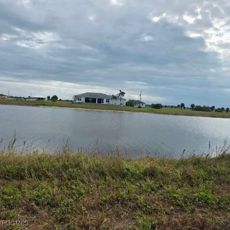 a view of a lake with houses in back