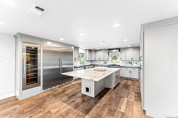 a large bathroom with a sink mirror and a bath tub