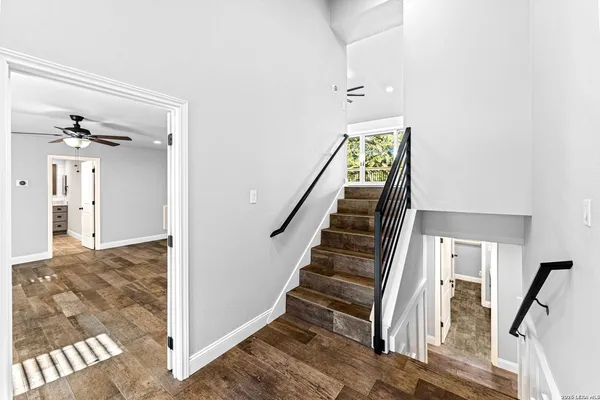 a view of a livingroom with a ceiling fan & a ceiling fan