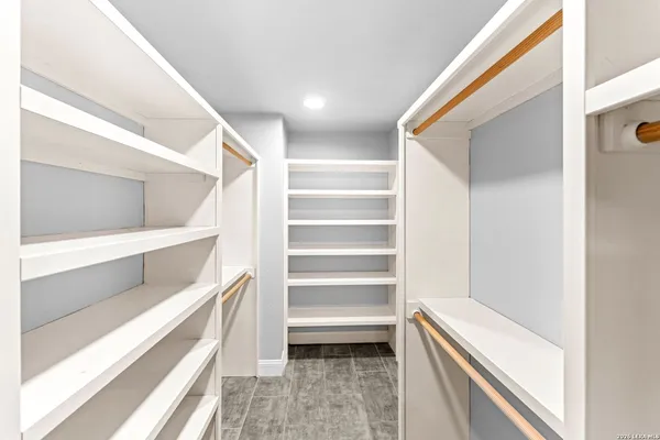 a view of a big room with wooden floor and a ceiling fan