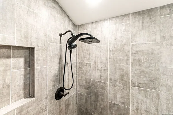 a view of a backyard with a garden and fire pit