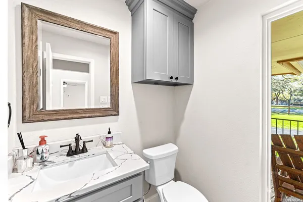 a front view of a house with a yard and trees