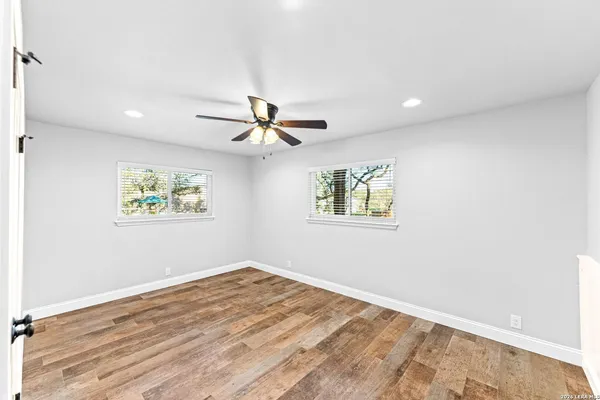 an aerial view of residential houses with outdoor space and trees