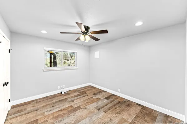 an aerial view of residential houses with outdoor space and trees