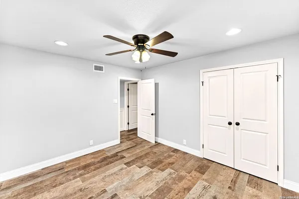 an aerial view of residential houses with outdoor space and trees