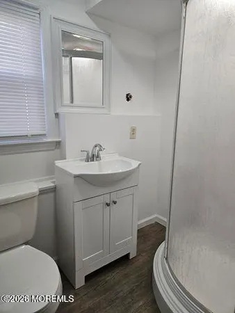 a bathroom with a sink a toilet and a mirror