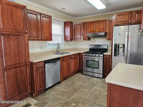 a kitchen with a sink stove and refrigerator
