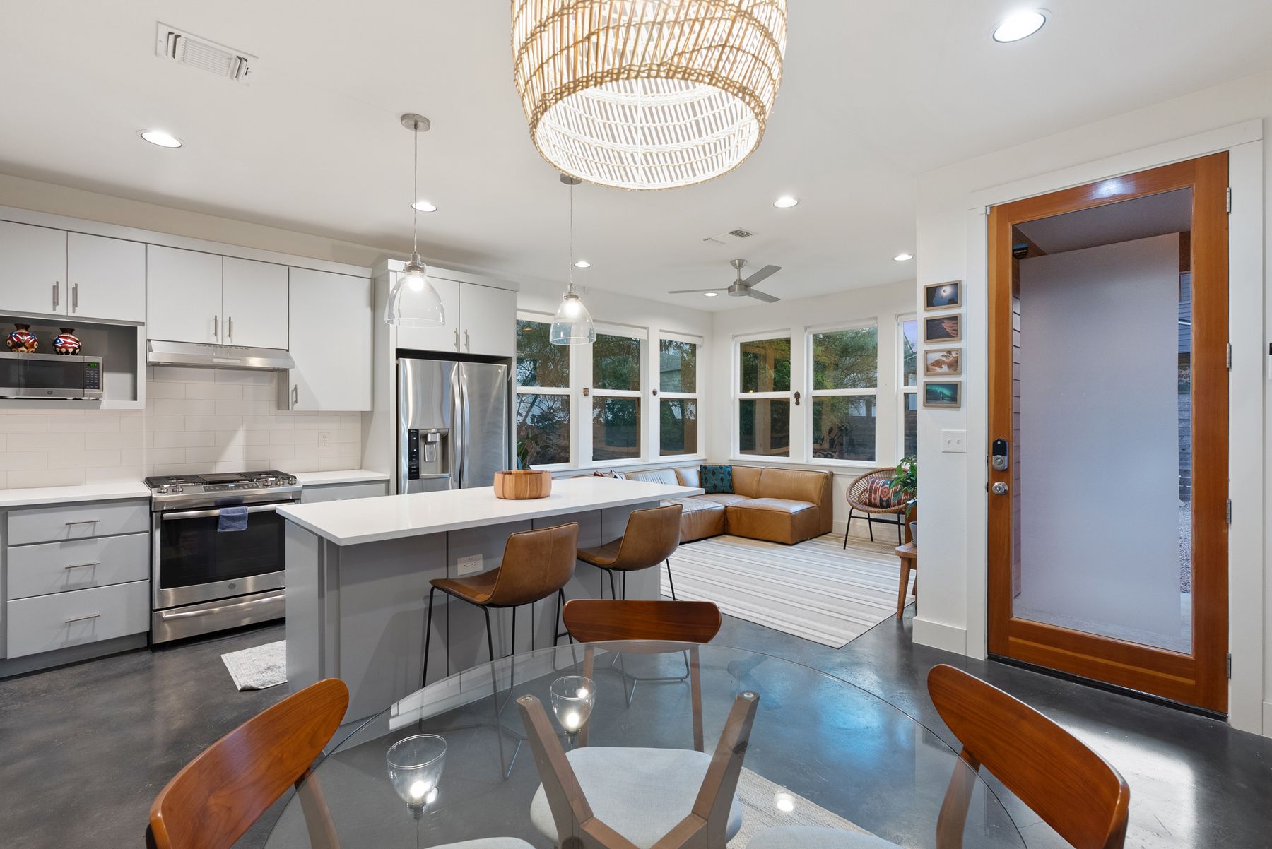 1709 Perez Street, Unit 2 Austin, TX 78721 - Photo 8 of 33 A well-lit kitchen with sleek countertops and integrated seating offers a bright and functional living space.