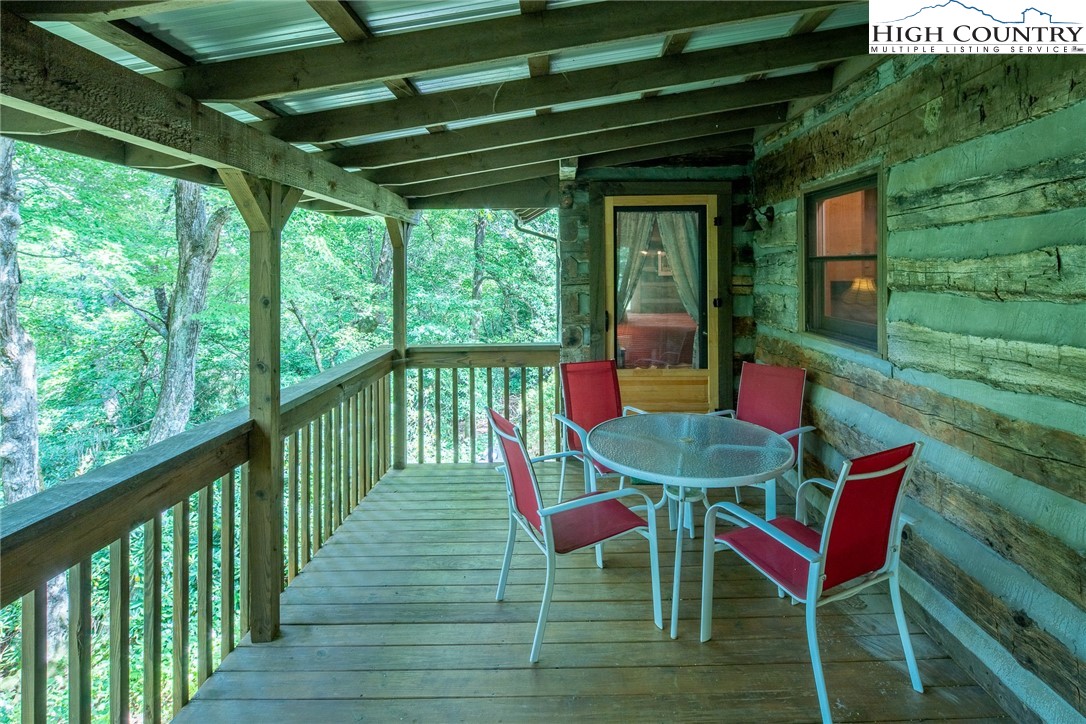 142 Teaberry Path Boone, NC 28607 - Photo 11 of 19 a balcony with table and chairs with wooden floor