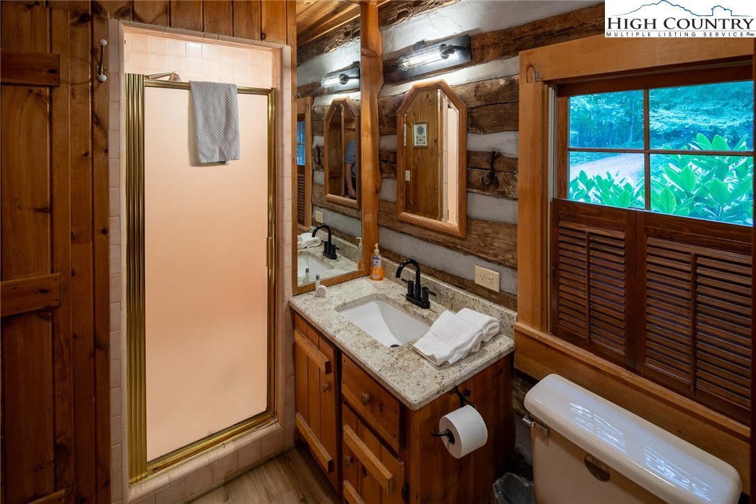 142 Teaberry Path Boone, NC 28607 - Photo 12 of 19 a bathroom with a sink a mirror and a shower
