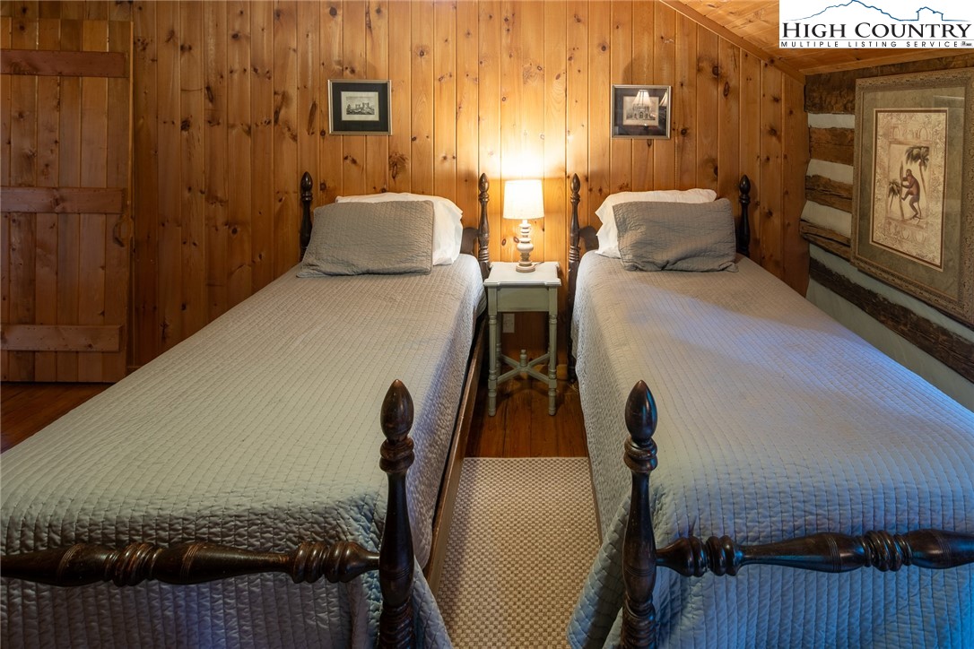 142 Teaberry Path Boone, NC 28607 - Photo 13 of 19 a bedroom with a bed and large windows