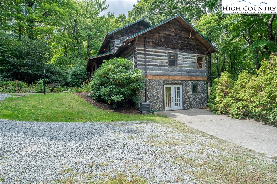 142 Teaberry Path Boone, NC 28607 - Photo 17 of 19 a house with a yard and a large parking space
