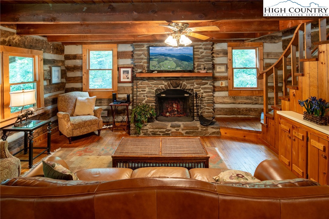 142 Teaberry Path Boone, NC 28607 - Photo 5 of 19 a living room with furniture a fireplace and a flat screen tv
