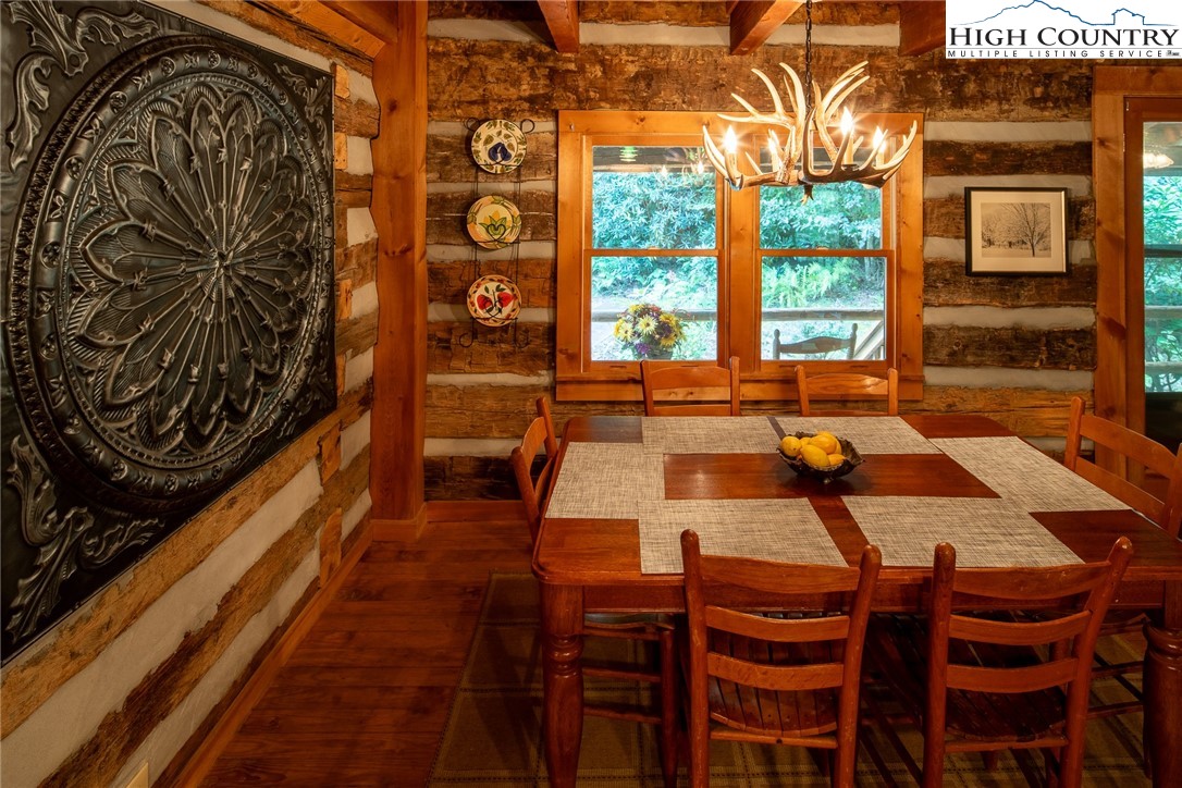 142 Teaberry Path Boone, NC 28607 - Photo 7 of 19 a dining room with furniture and a floor to ceiling window