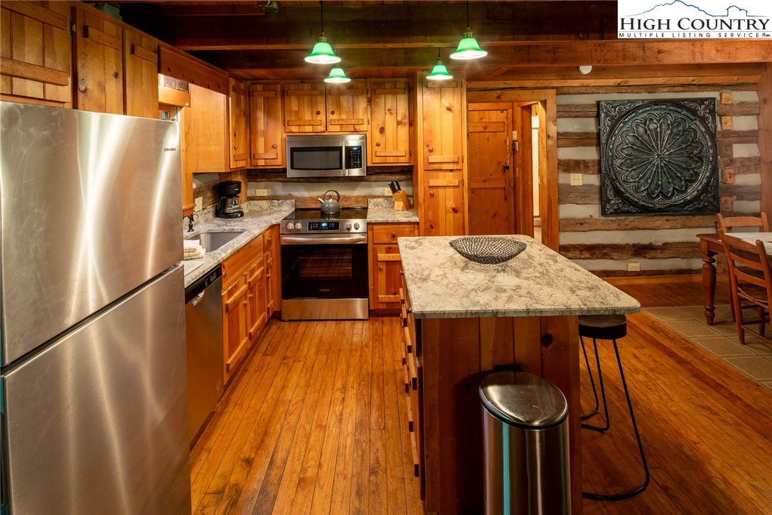 142 Teaberry Path Boone, NC 28607 - Photo 9 of 19 a kitchen with stainless steel appliances granite countertop a refrigerator a stove and a wooden floor