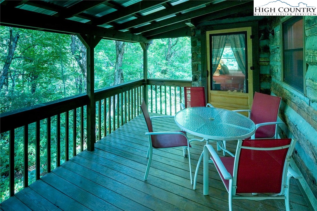 142 Teaberry Path Boone, NC 28607 - Photo 10 of 19 a view of a chairs and table in patio with a yard