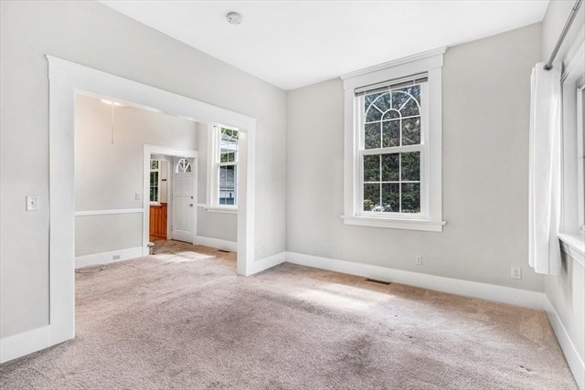 54 Harris Street, Unit 54 Acton, MA 01720 - Photo 5 of 9 an empty room with windows and cabinet