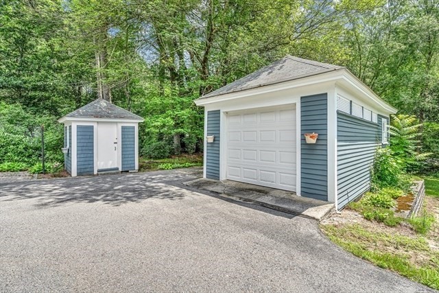 54 Harris Street, Unit 54 Acton, MA 01720 - Photo 9 of 9 a front view of a house with a yard and garage