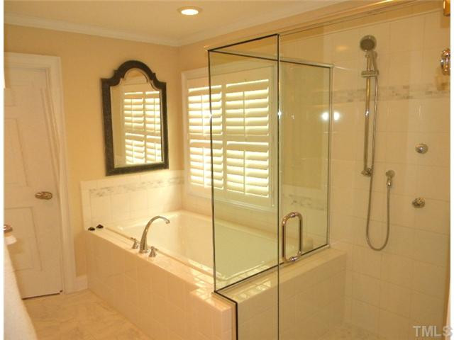 3704 Laurel Hills Road Raleigh, NC 27612 - Photo 15 of 25 Large msater features ceramic tile with decorative banding, "Tea for Two" extra deep cast iron soaking tub and two person full body spray shower. Master Bath/Spa