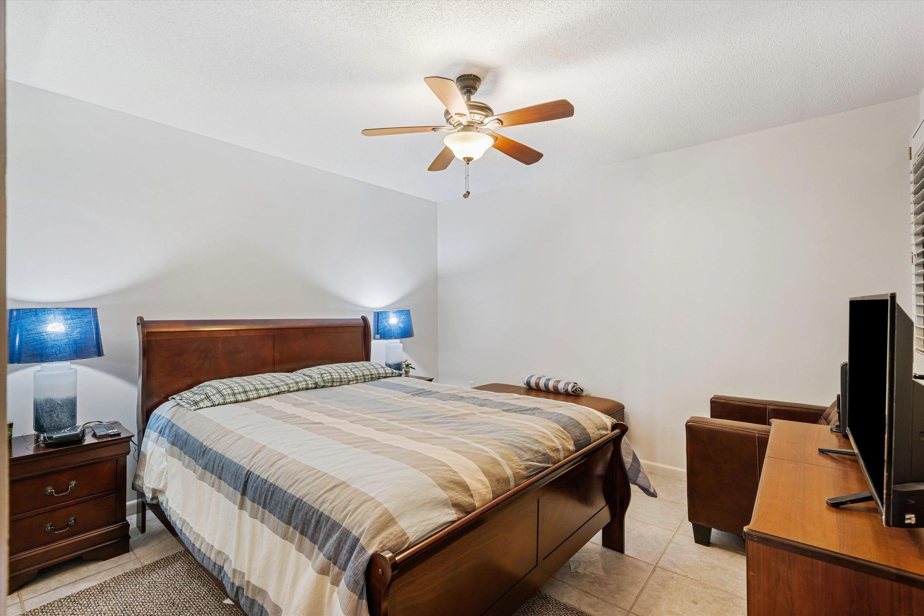 200 Wagner Street, Unit 604 Memphis, TN 38103 - Photo 19 of 36 Bedroom with ceiling fan, light tile patterned flooring, and a textured ceiling