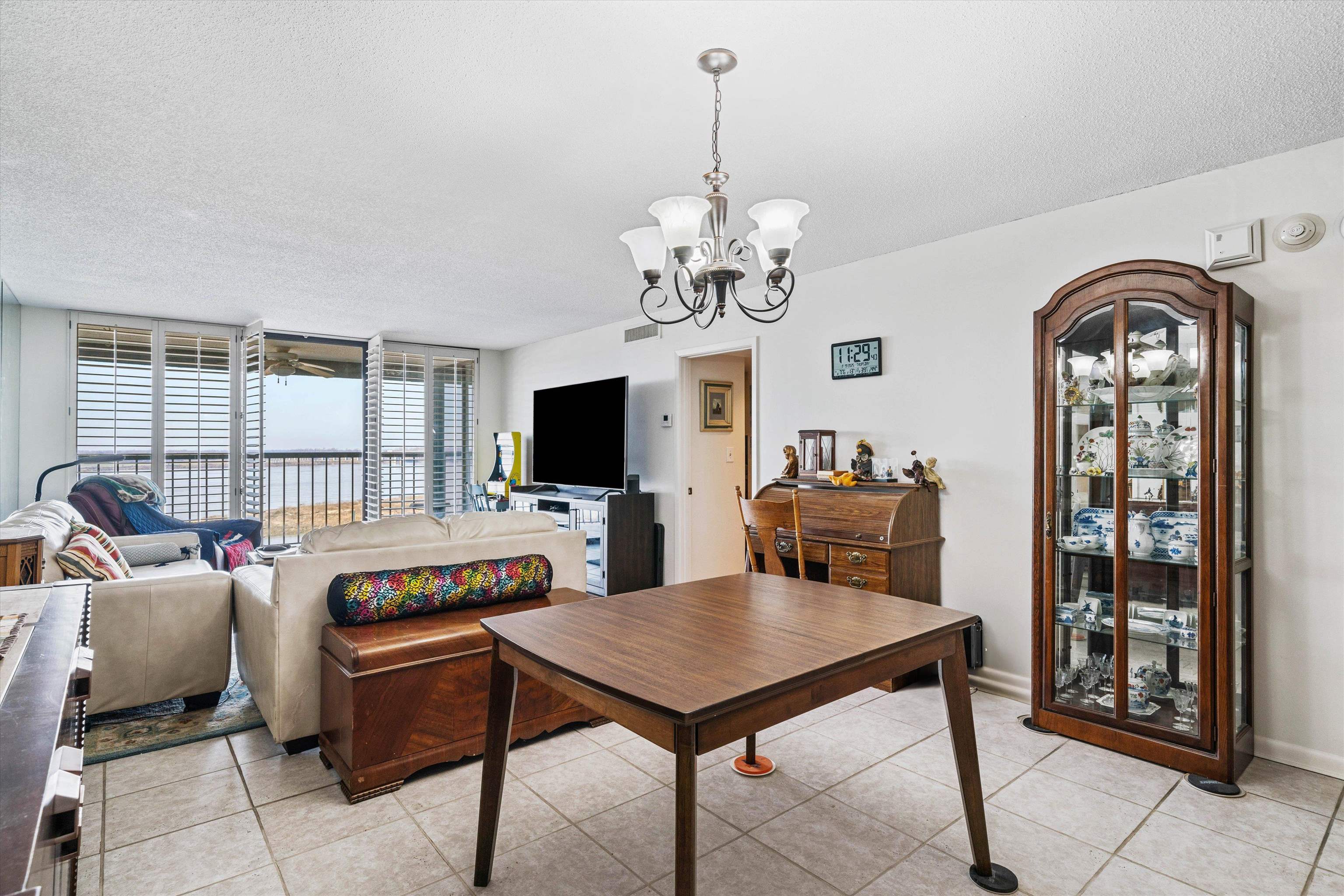 200 Wagner Street, Unit 604 Memphis, TN 38103 - Photo 6 of 36 Living area featuring hanging lights, a textured ceiling, floor to ceiling windows, and light tile patterned floors