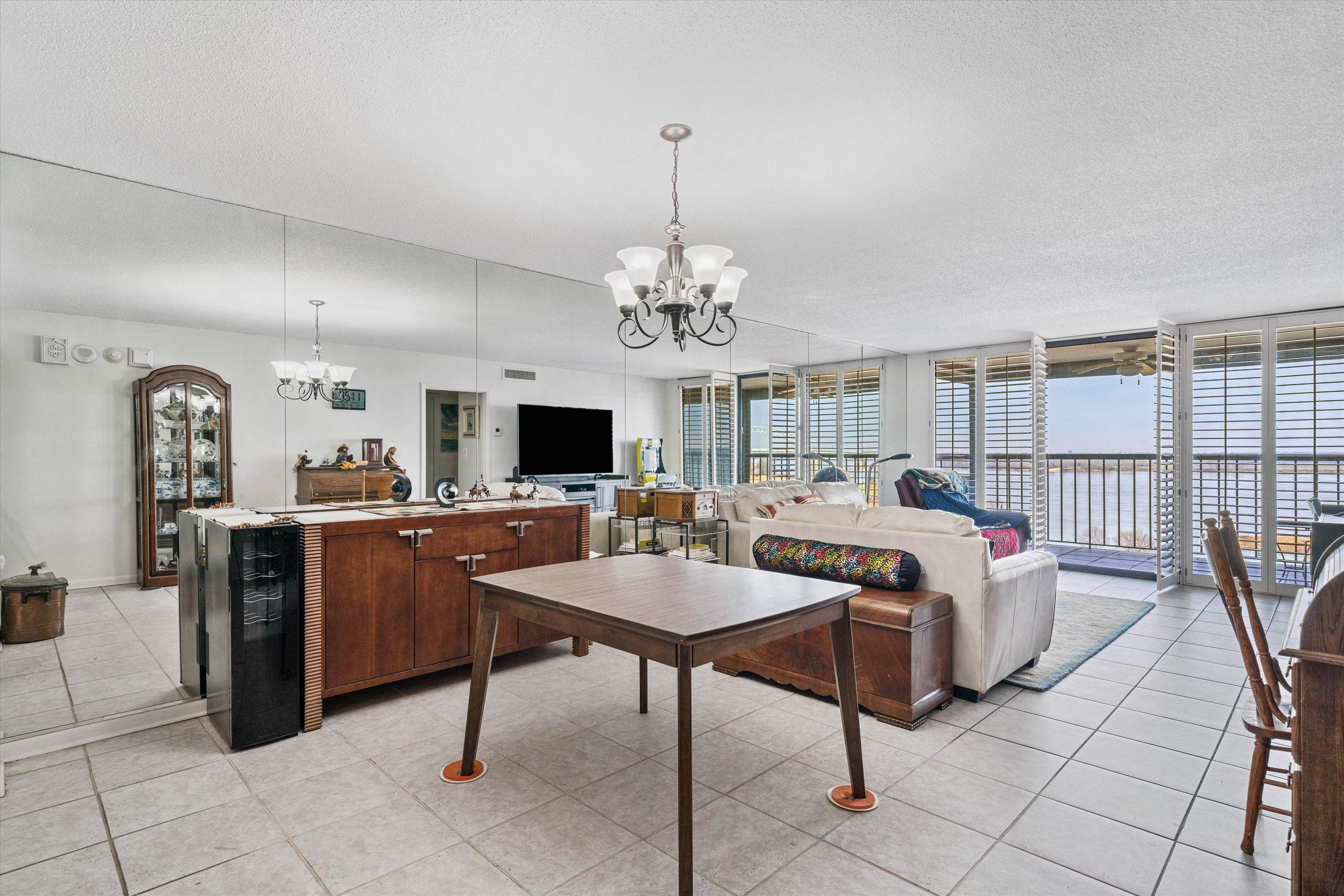 200 Wagner Street, Unit 604 Memphis, TN 38103 - Photo 7 of 36 Living area with a chandelier, floor to ceiling windows, light tile patterned floors, and a textured ceiling