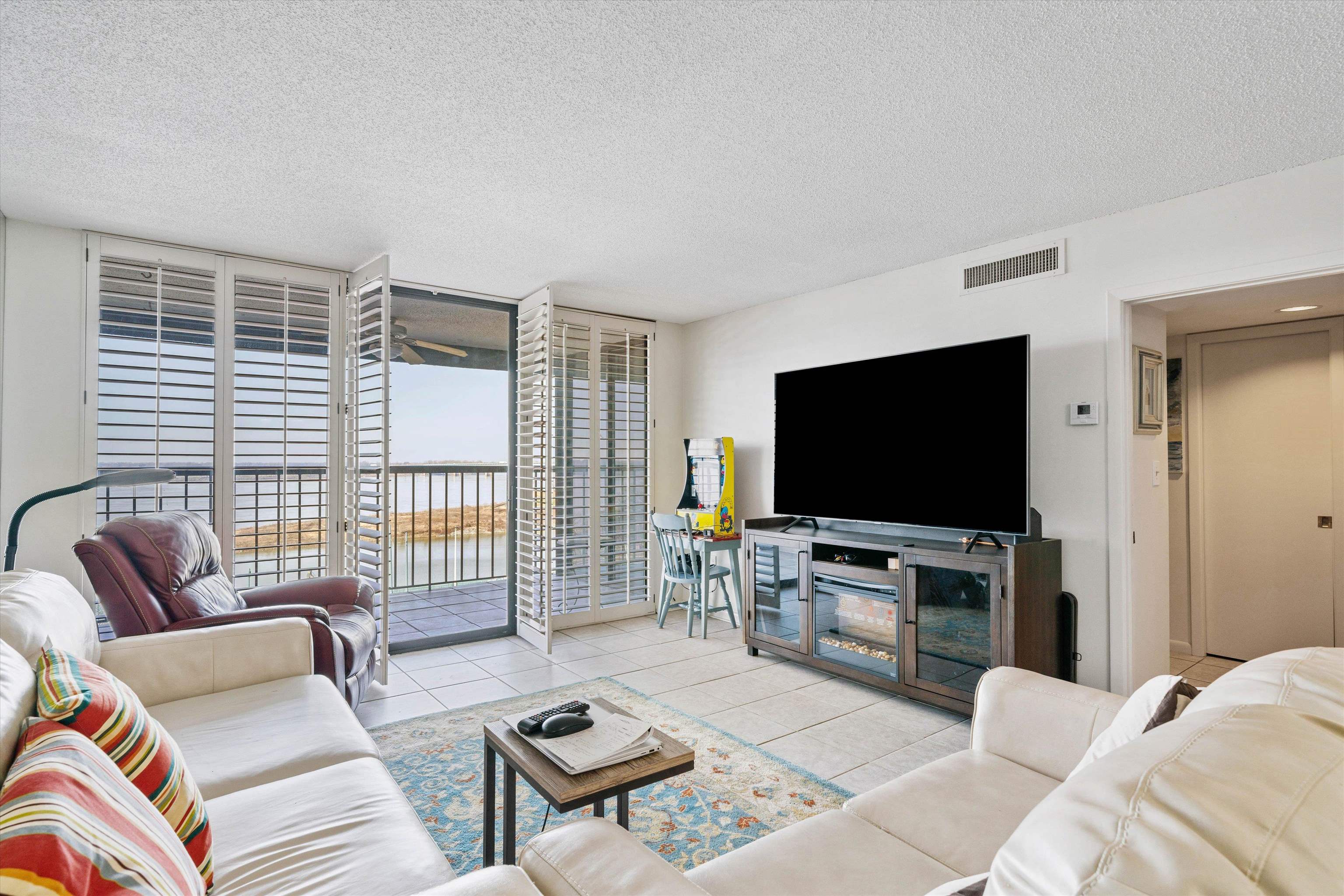 200 Wagner Street, Unit 604 Memphis, TN 38103 - Photo 9 of 36 Living area with floor to ceiling windows, light tile patterned floors, and a textured ceiling
