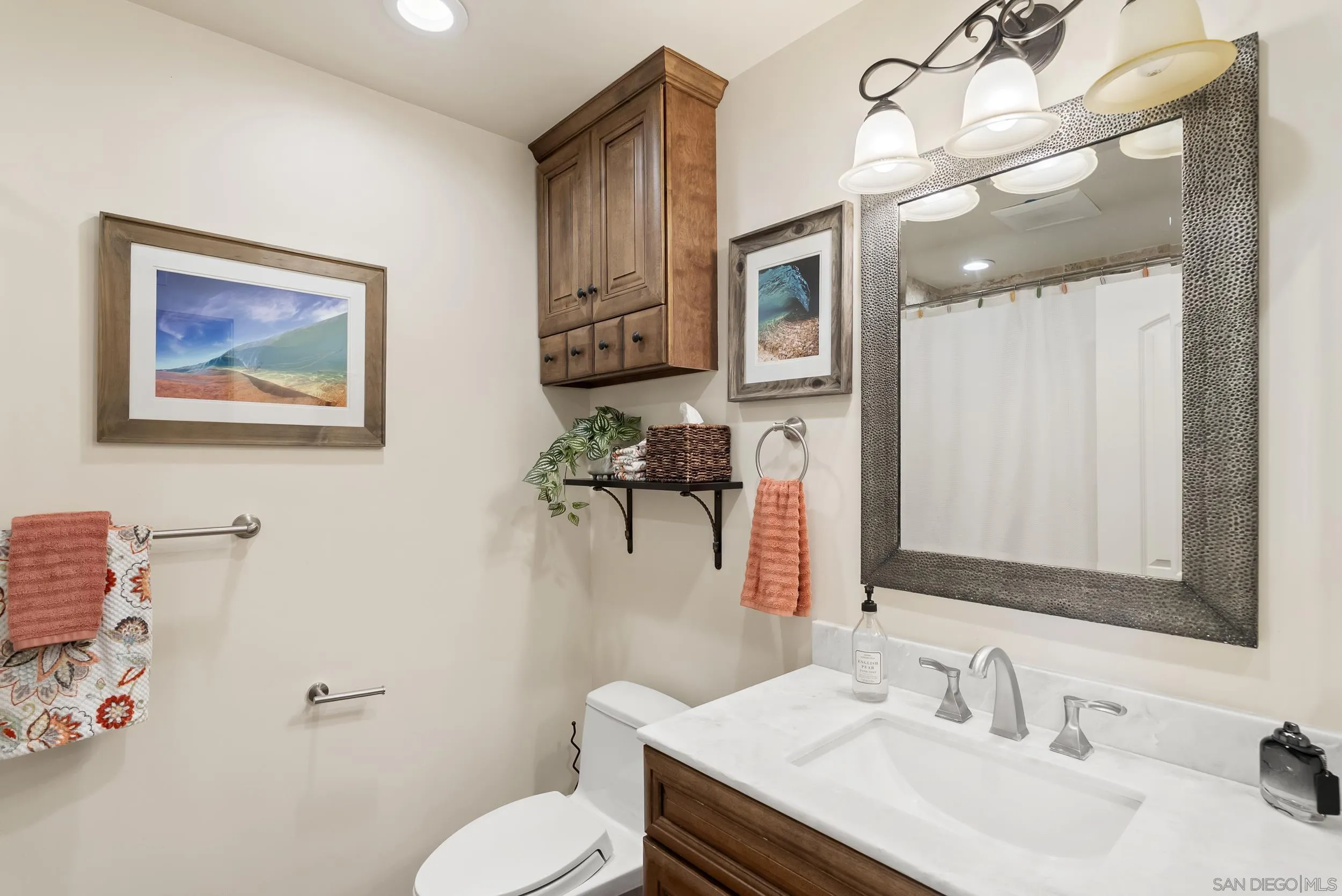 489 La Costa Avenue Encinitas, CA 92024 - Photo 17 of 45 a bathroom with a granite countertop sink mirror and toilet