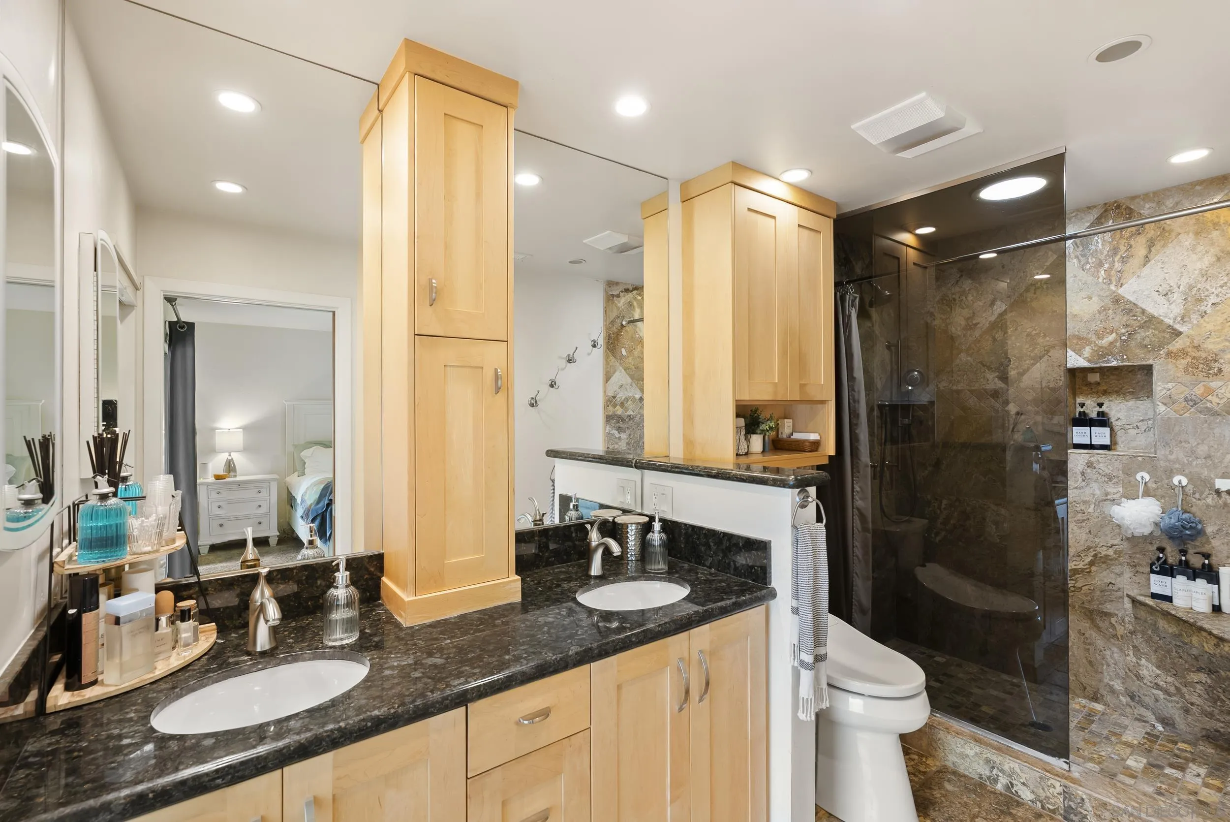 489 La Costa Avenue Encinitas, CA 92024 - Photo 19 of 45 a bathroom with a granite countertop sink a toilet a mirror and shower