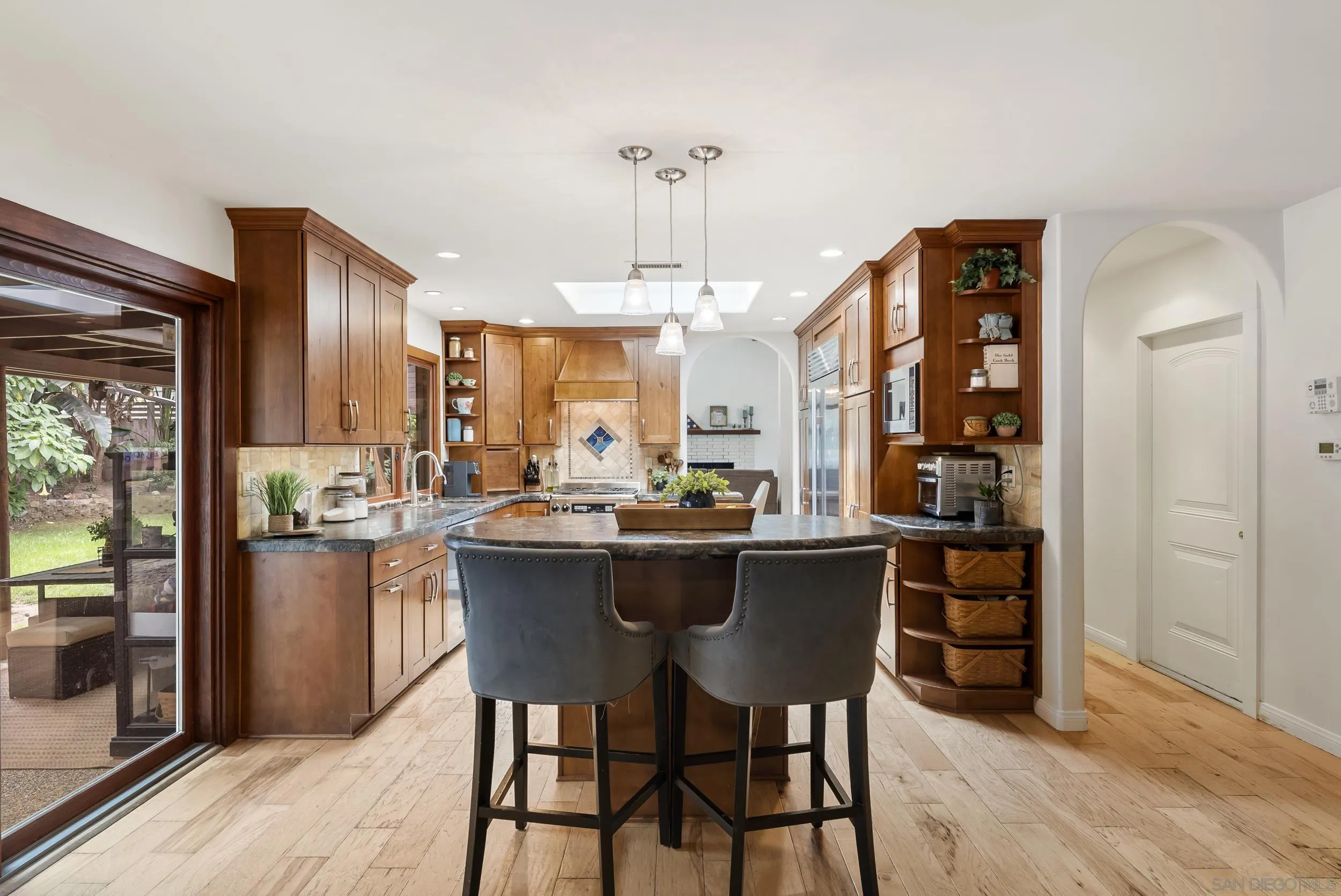 489 La Costa Avenue Encinitas, CA 92024 - Photo 10 of 45 a kitchen with a dining table chairs stainless steel appliances and cabinets