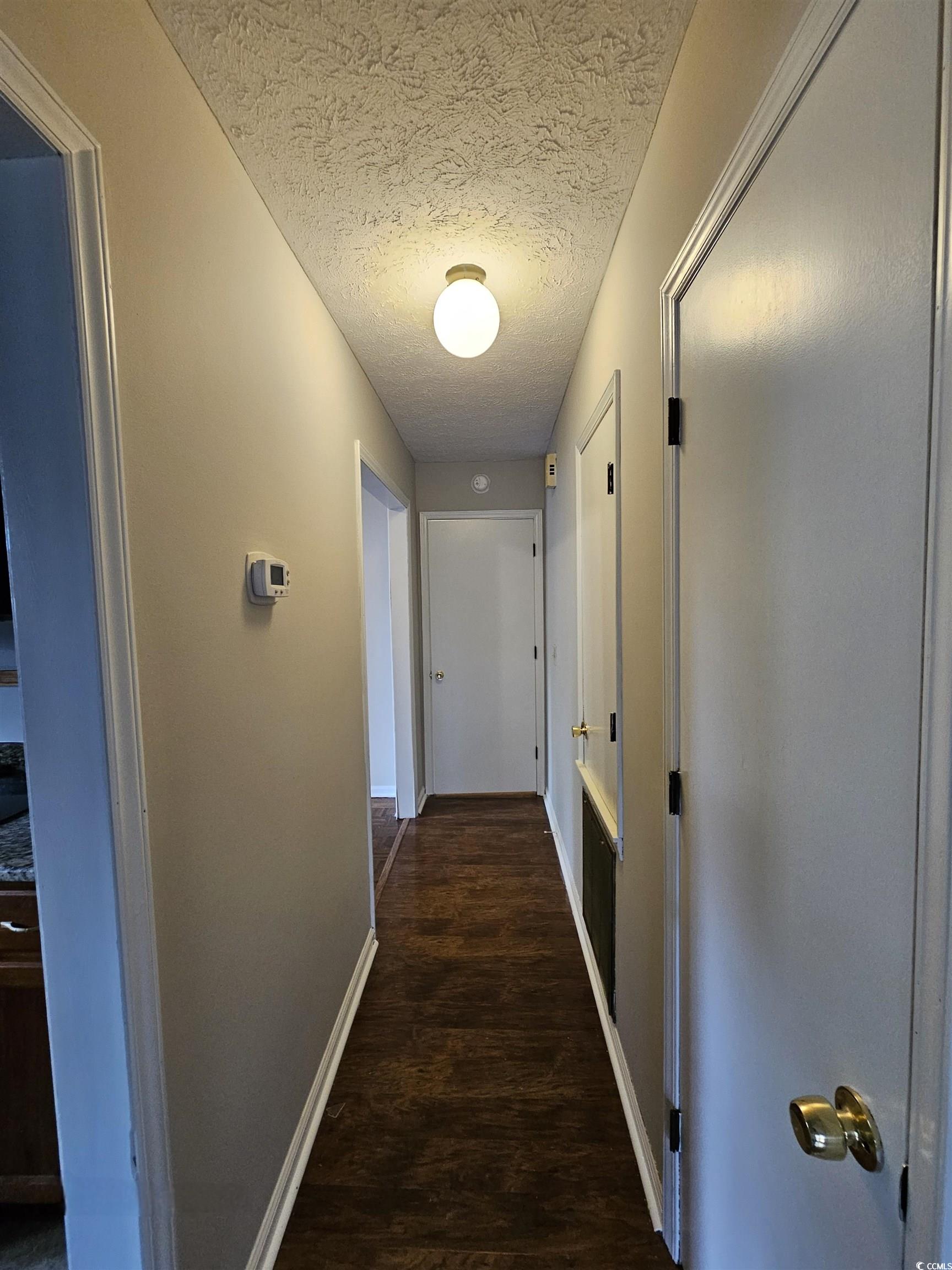 117 Partridge Berry Road Myrtle Beach, SC 29579 - Photo 17 of 33 Hall featuring a textured ceiling and dark wood finished floors