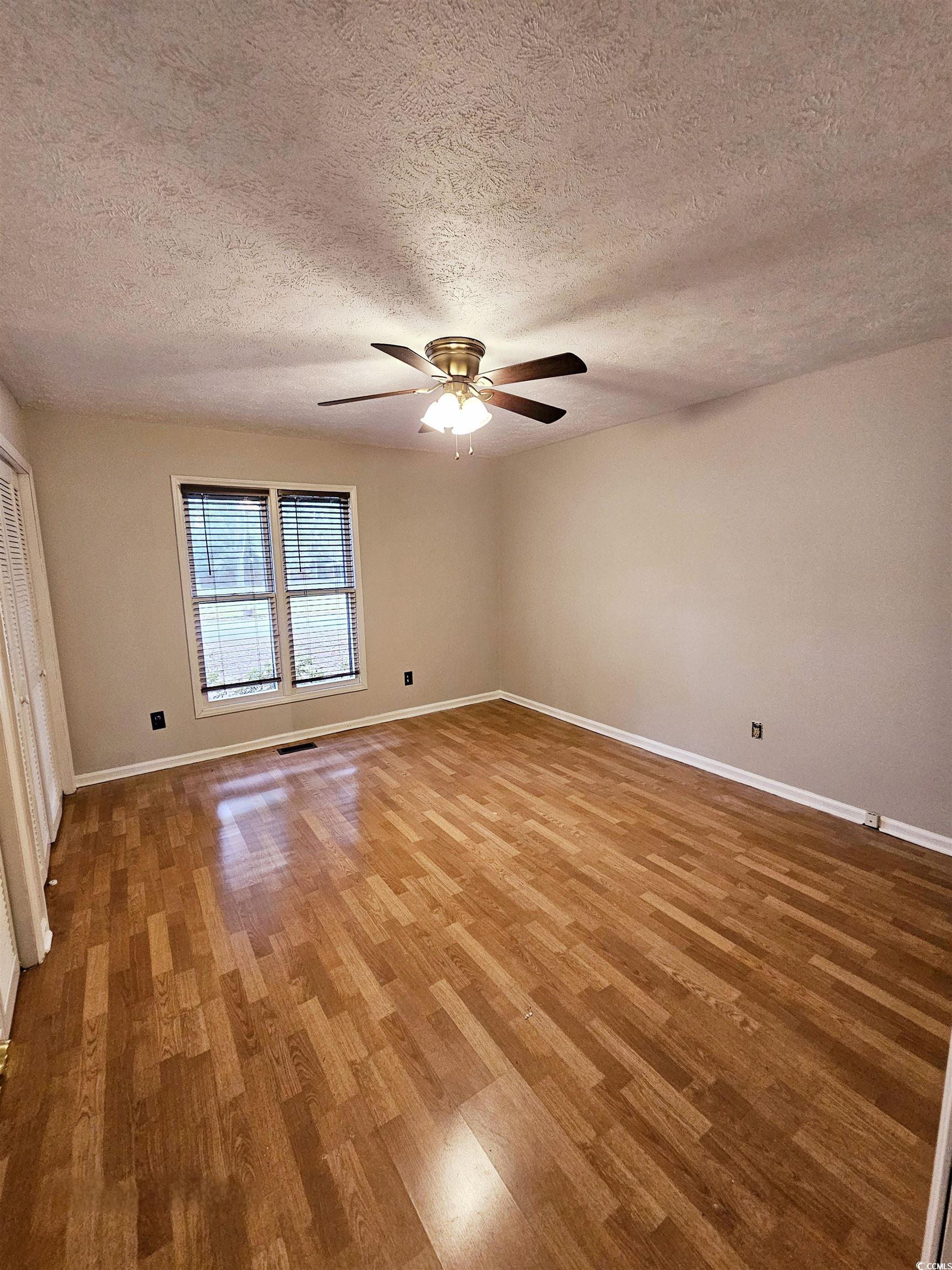 117 Partridge Berry Road Myrtle Beach, SC 29579 - Photo 18 of 33 Unfurnished room with a textured ceiling, wood finished floors, and ceiling fan