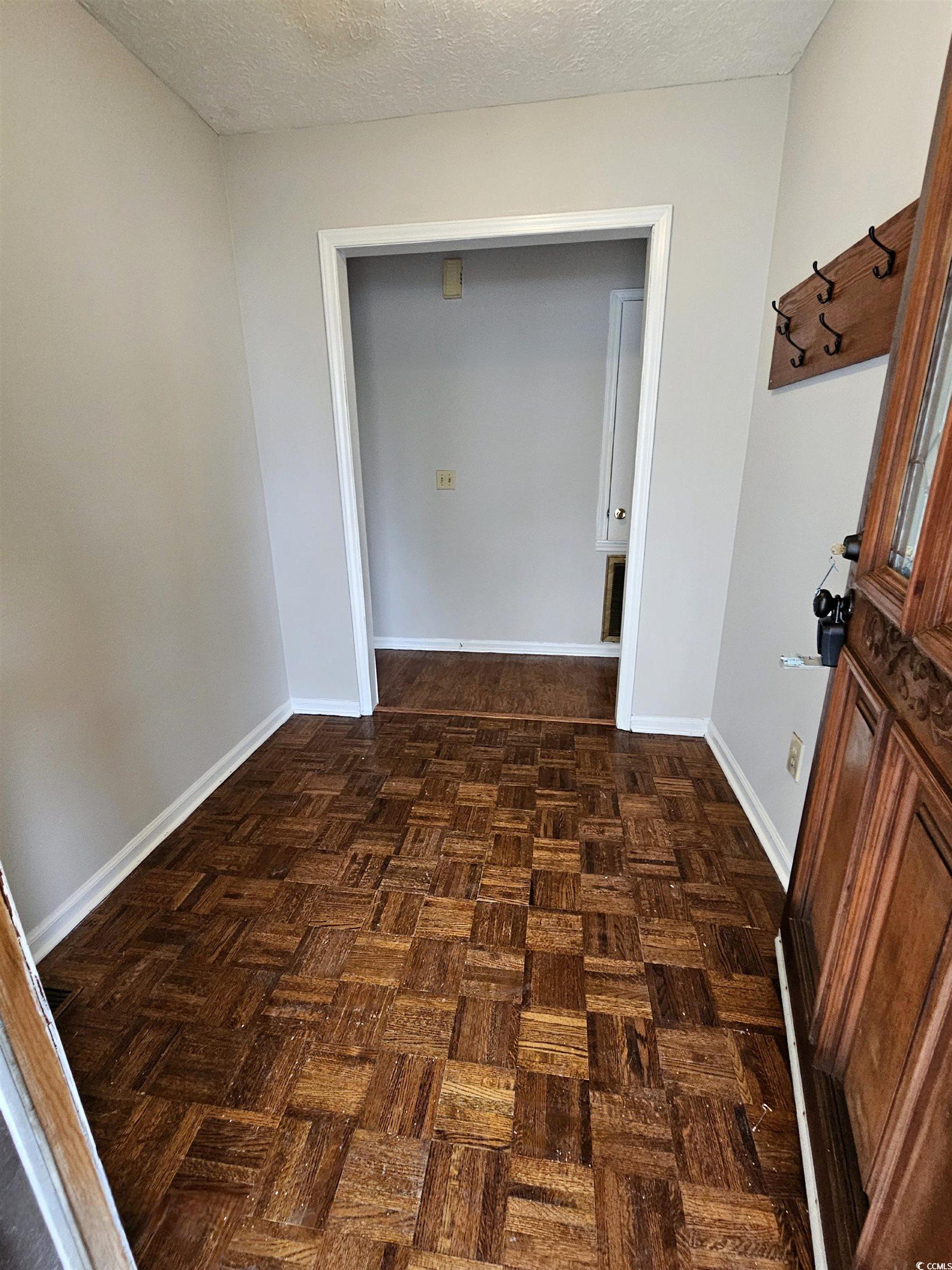 117 Partridge Berry Road Myrtle Beach, SC 29579 - Photo 3 of 33 Hallway featuring baseboards and a textured ceiling
