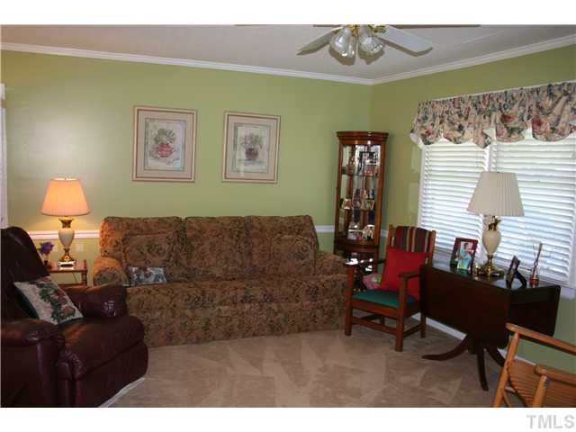 506 Parham Road Henderson, NC 27536 - Photo 5 of 12 a living room with furniture a chandelier and a window