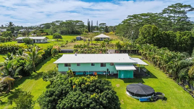 an aerial view of a house with yard swimming pool and outdoor seating