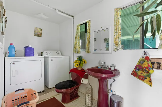 a room with a baby bed furniture and a window