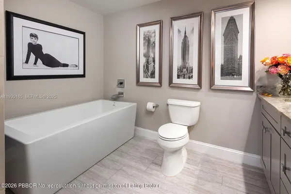 a white toilet sitting next to a bathroom sink