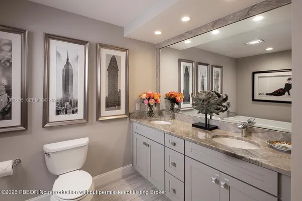 a bathroom with double sink and a toilet