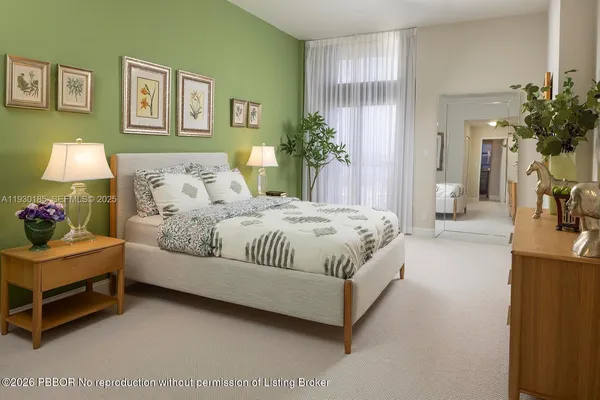 a bedroom with a bed and lamp