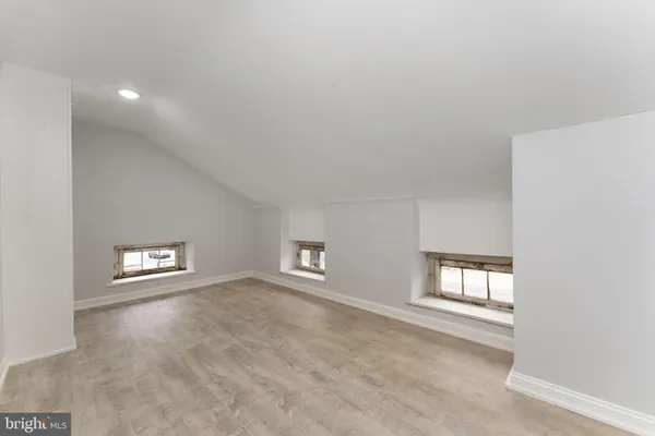 an empty room with windows and closet