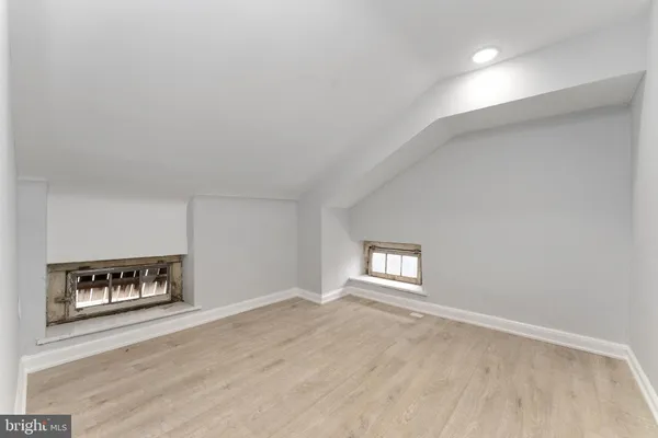 an empty room with windows and cabinet