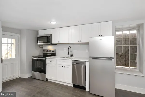 a white refrigerator freezer sitting in a kitchen