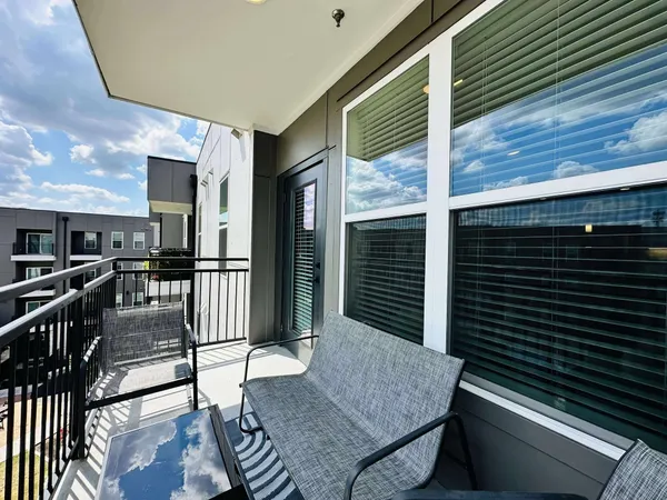 a balcony view with a seating space