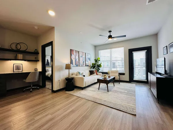 a living room with furniture and a wooden floor