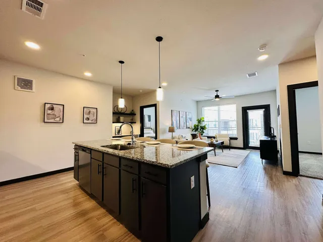 a kitchen with sink stove and refrigerator
