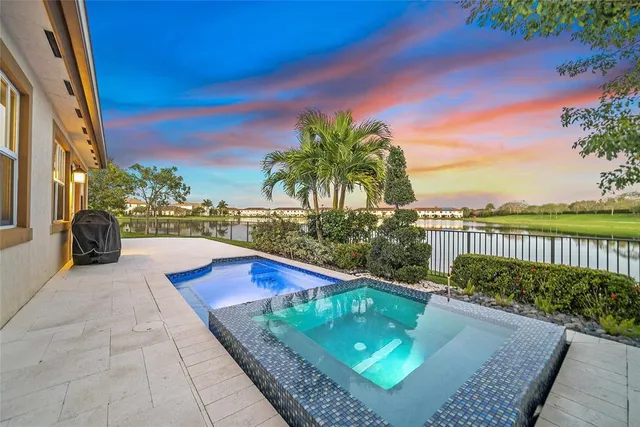 an aerial view of a house with a lake view