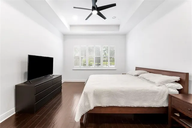a bedroom with a large bed and a chandelier