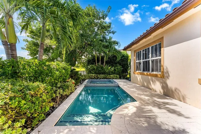 a living room with furniture a large window and wooden floor