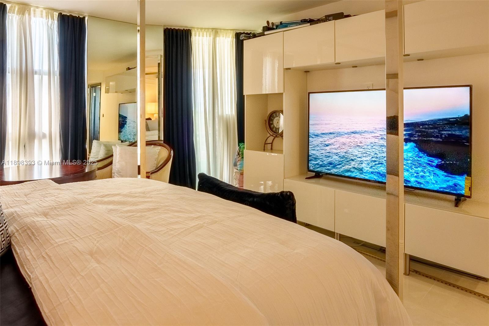 4000 Towerside Terrace, Unit 410 Miami, FL 33138 - Photo 23 of 74 a bedroom with a large window and a bed